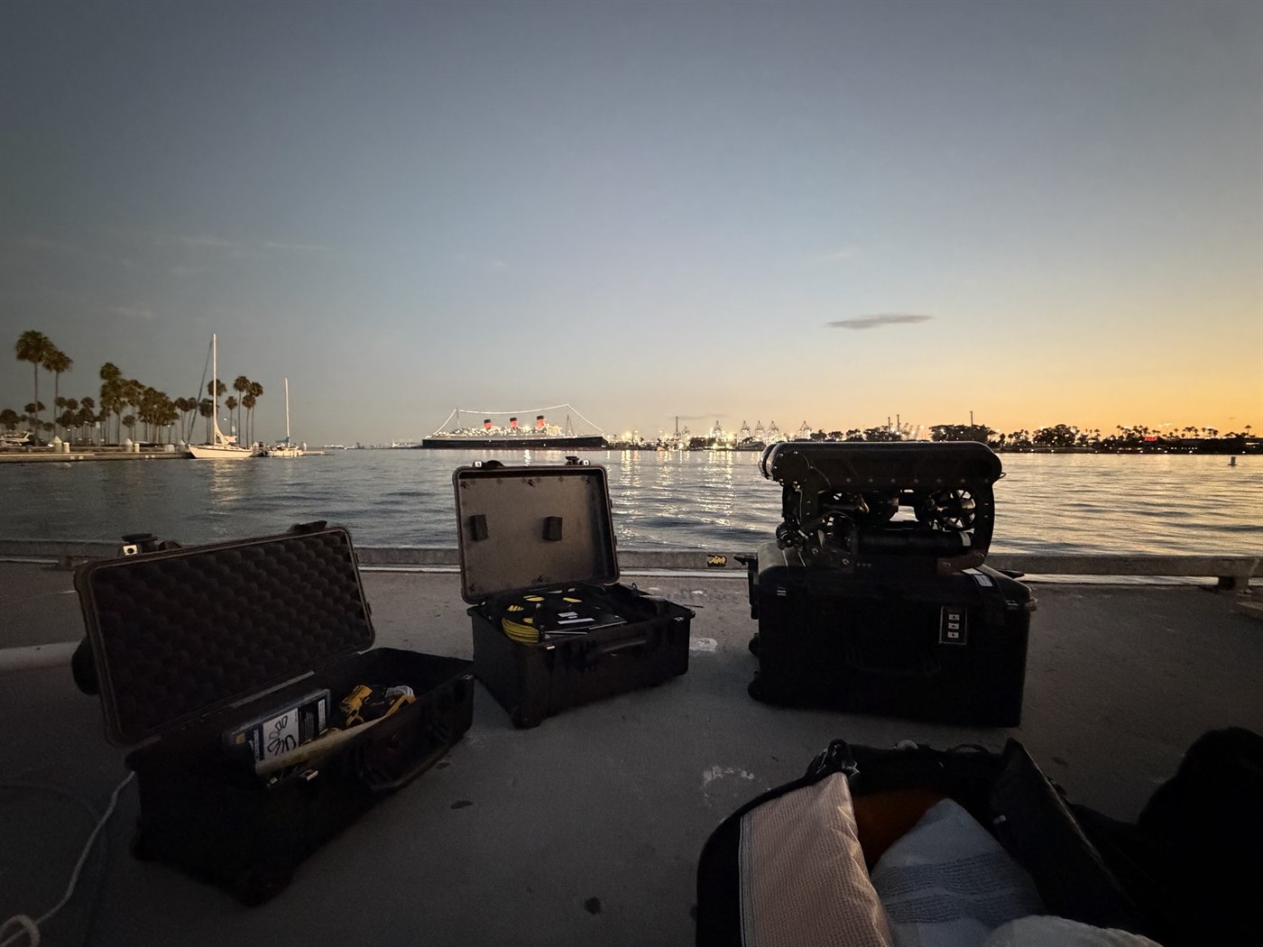 ROV and equipment cases on a dock at dusk