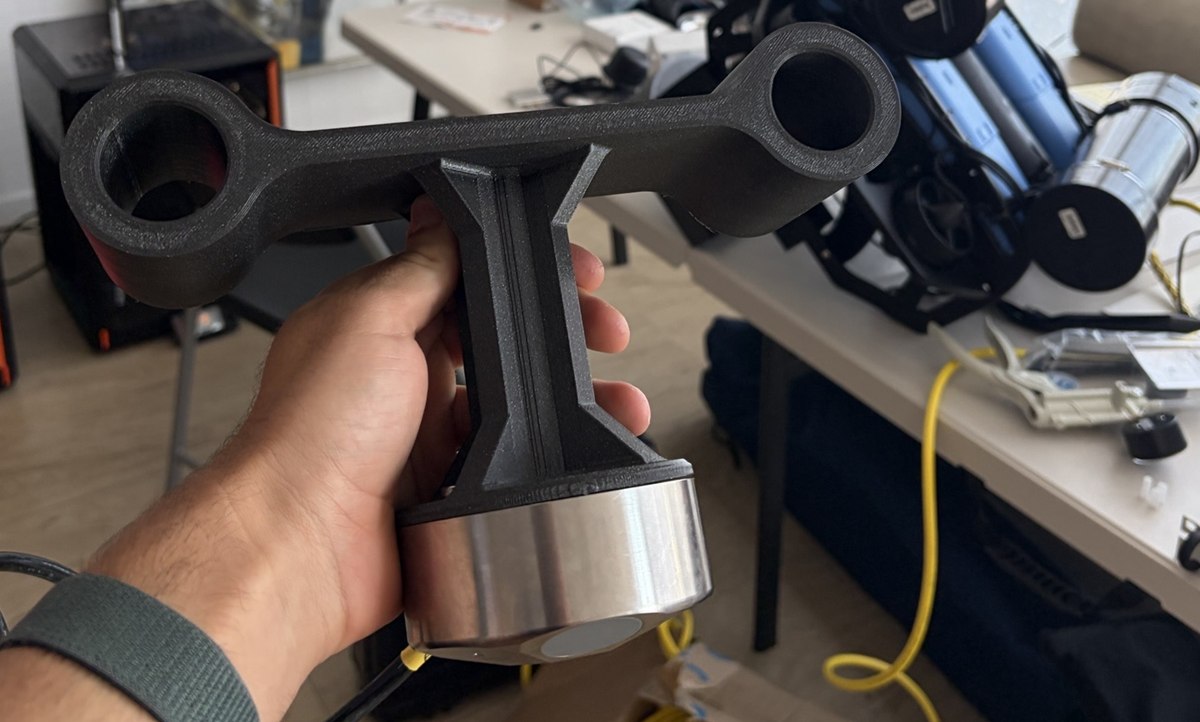 A 3D-printed DVL mounting jig held in one hand